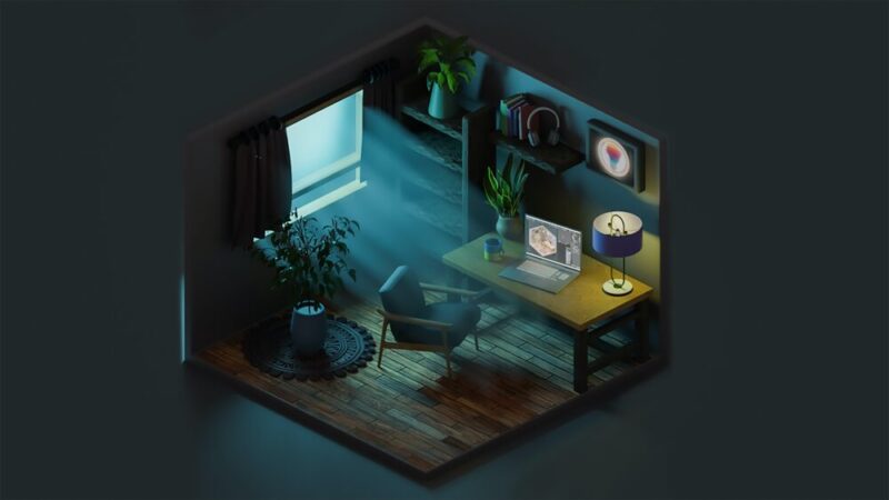 room with a computer with light coming in through the window