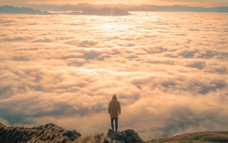 standing on top of a mountain and looking at the sea of clouds