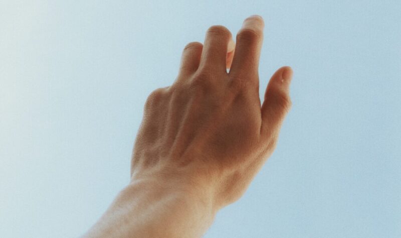 left hand extended toward the sky